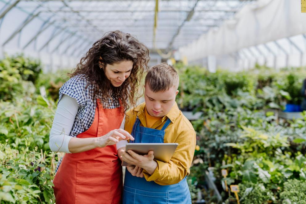 Woman and Child on tablet in glashouse